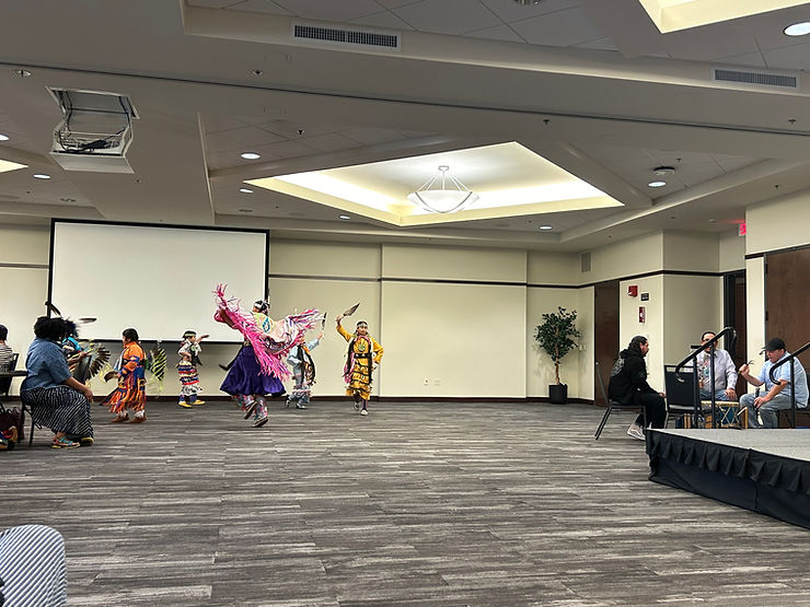 A photo of a round dance performance in the conference room